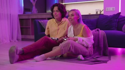 Happy Couple Plays Video Games Together at Home