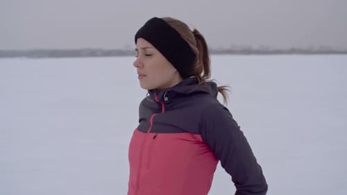 Woman Stretching Arms Outdoors in Winter