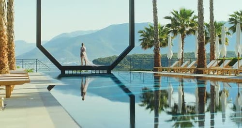 Young lady standing over the pool on holidays. Travel vacation woman relaxing enjoying Montenegro