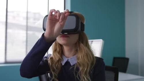 Woman Uses Virtual Reality Headset in Office