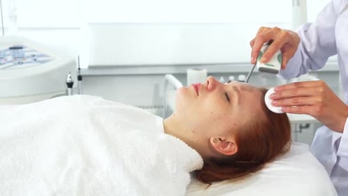 Young Woman Receiving Facial Treatment at Medical Spa