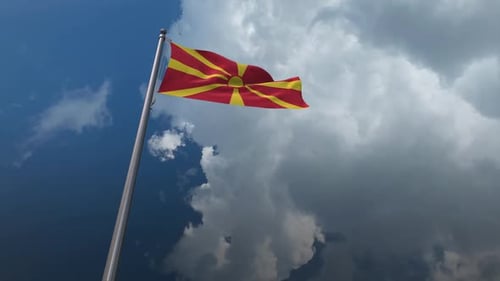 North Macedonia Flag Waving on Pole with Cloudy Sky Loop