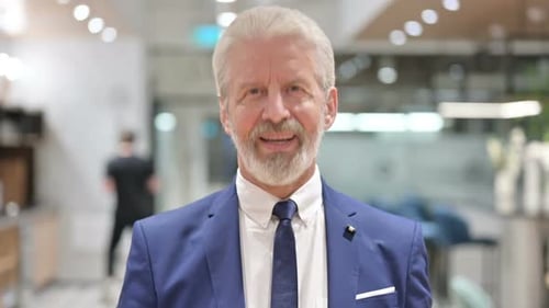 Mature Businessman Smiling Confidently in an Office Building