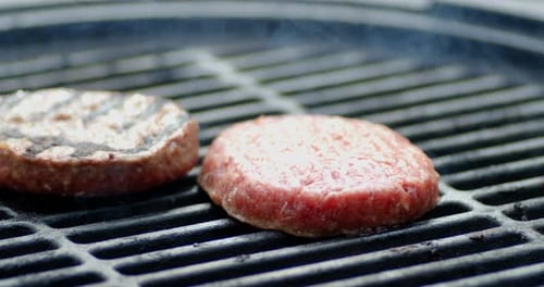 The Spatula Is Turned Over the Beef Burger on the Grill.
