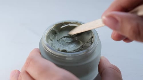 Wooden Spatula Scooping Face Mask from Jar