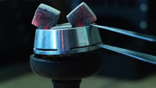 Hot Coals Added to Hookah Bowl Preparation