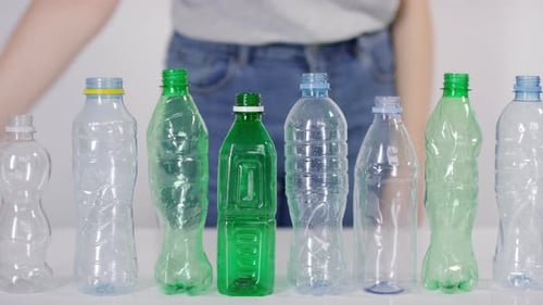 Smashing Row Of Plastic Bottles From Table
