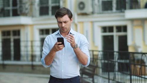 Portrait Man Typing on Phone at Street. Businessman Using Smartphone Outdoors