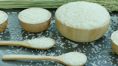 White Rice in Wooden Bowls and Spoons