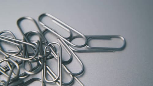 Motion Over School and Office Paperclips on Grey Surface