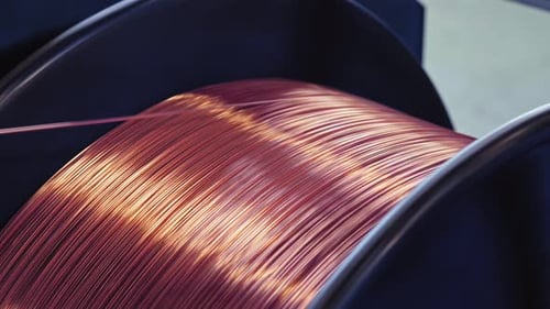 Copper Wire Unwinding From A Spool. Close Up