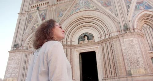 Traveler woman in hat sightseeing antique cathedral