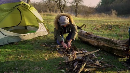 Tourist Lights a Fire Near the Tent