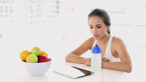 Hermosa joven tomando una copa después de trabajar