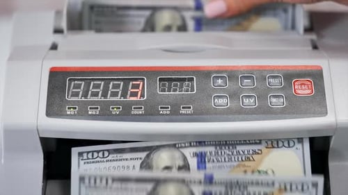 Automatic Currency Counter Counting One Hundred Dollar Bills