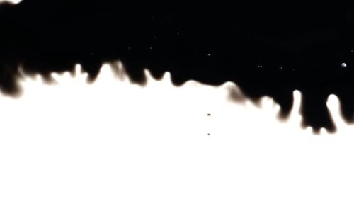 Abstract Ink Spreading Across White Surface