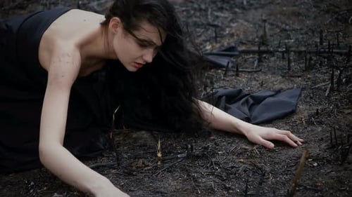 Woman Lying on Barren, Post-Apocalyptic Landscape