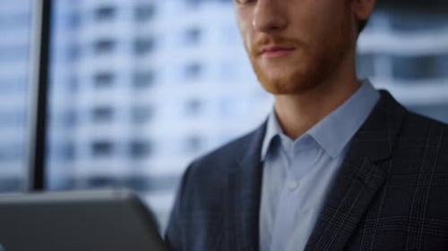 Focused Businessman Working Digital Tablet in Office