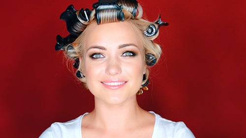 Blonde Woman Smiling with Hair Curlers in