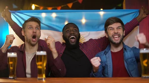 Emotional Black and Caucasian Men Cheering for Argentinian Football Team, Bar