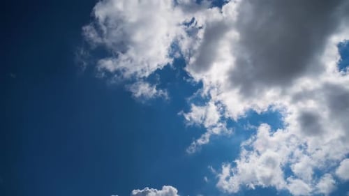 Clouds Floating Across a Blue Sky in Daytime