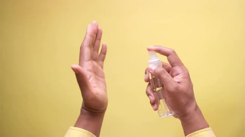 Close Up of Young Man Hand Using Hand Sanitizer Spray