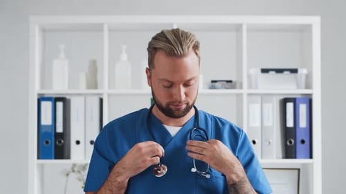 Professional medical doctor in hospital office, Portrait of young and confident physician.