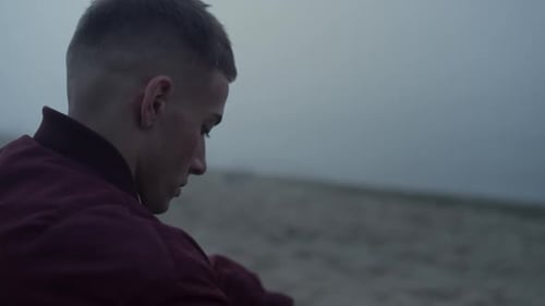 Sad Man Sitting Sandy Beach in Morning