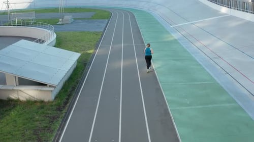 Aerial View of Plus Size Female Running on Track
