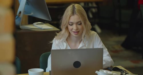 Happy Female Using Laptop Computer Drinking Coffee Sitting at Table in Cafe Remote Studying