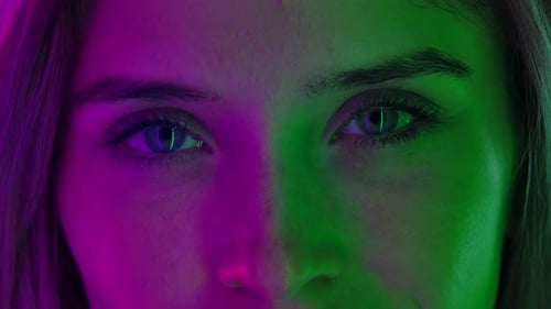 Womens Face Neat Natural Makeup Illuminated Colorful Neon Light Look Straight Ahead