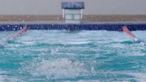 Swimmer swimming into the pool