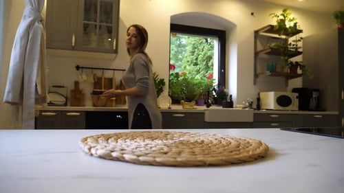Woman Presents Delicious Chocolate Cake in Kitchen