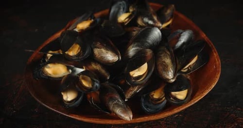 Delicious Mussels Displayed on a Rustic Wooden Plate