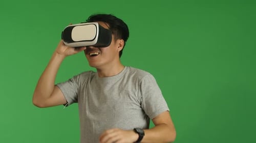 Man Experiencing Virtual Reality on Green Screen