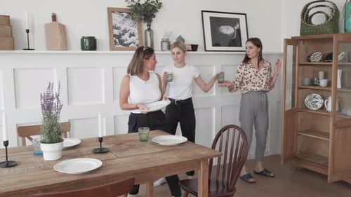 Three Women Setting Table for a Gathering