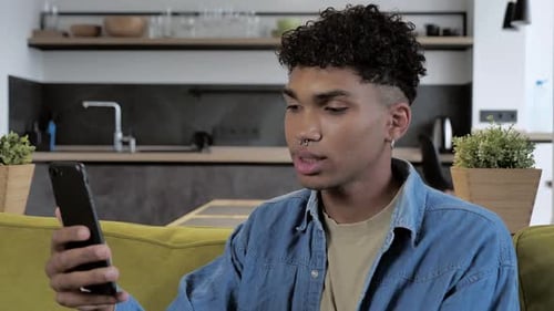 Man Video Calling on Smartphone in Home Interior