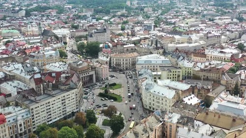 Old historical European city with cars driving along the road of Lviv Ukraine and the skyline in the