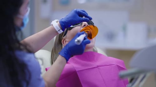 Dentist Performing Procedure on Child Patient