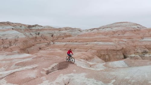 Drone Shot of Bicyclist Ride in Canyon Desert Mountains in Kazakhstan