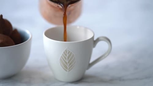 Pouring Hot Drink Into Elegant White Mug