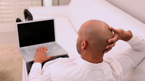 Adult Works on Laptop While Reclining at Home