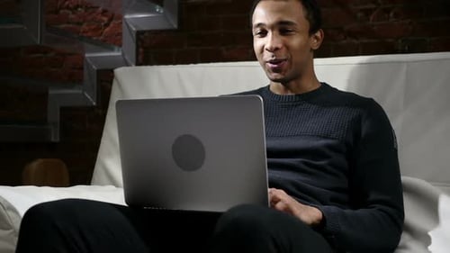 Young Adult Man Video Calling on Laptop