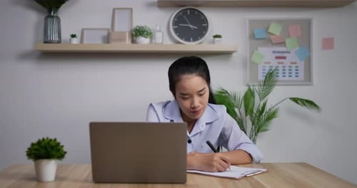 Young Woman Working at Desk with Laptop