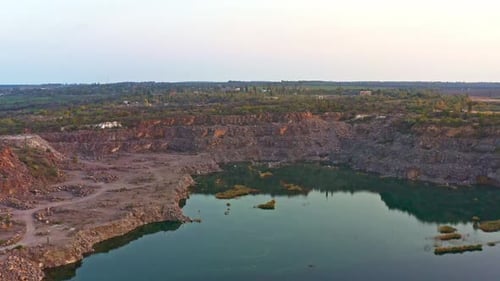 Old Flooded Stone Quarry Surrounded By Large Stones