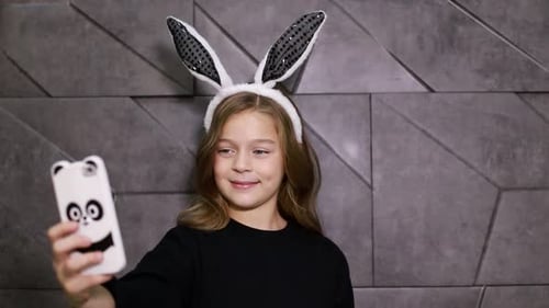 Girl with Bunny Ears Taking Selfie