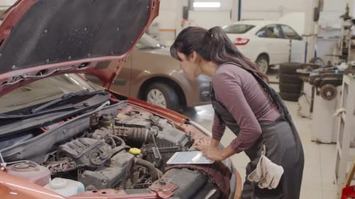 Female Mechanic Doing Car Diagnostic with Tablet