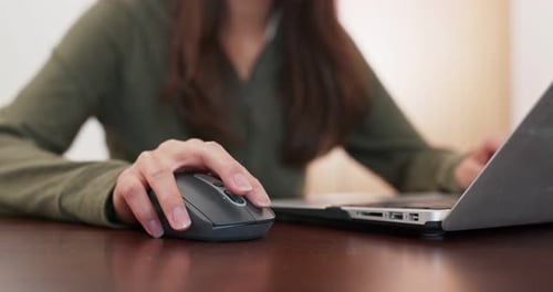 Close-Up of Woman Using Mouse With Laptop