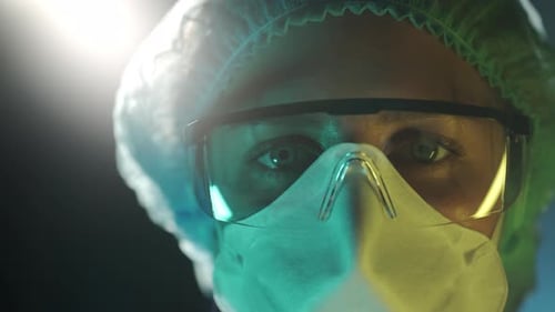 Portrait of a Female Doctor in Medical Uniform is Looking at Camera at Hospital Close Up