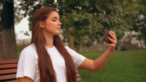 Young Woman Taking a Selfie in the Park